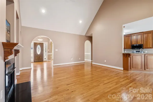 a view of a kitchen with furniture and wooden floor