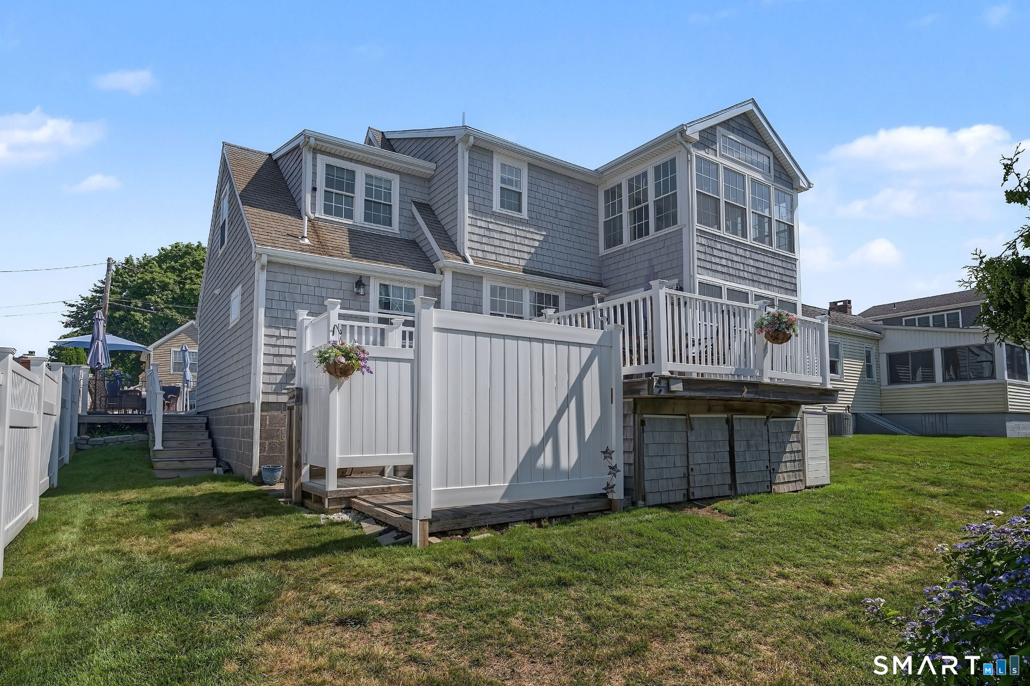 3 Mohican Road West Westbrook, CT 06498 - Photo 34 of 40 The back yard has a large with stairs to the lower deck and outdoor shower.