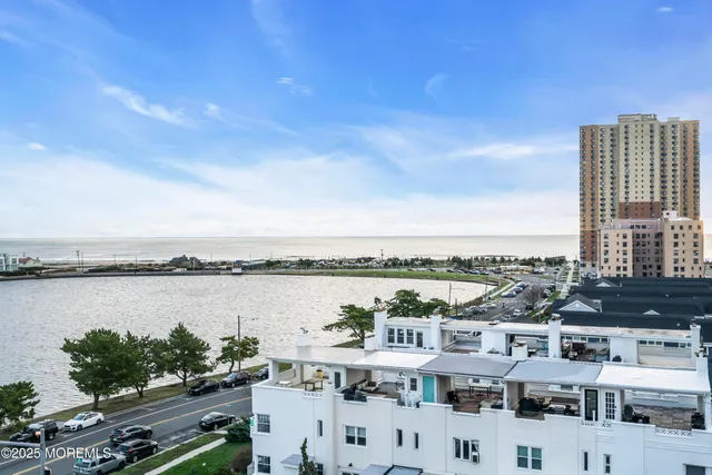 a view of a lake with tall buildings in the background