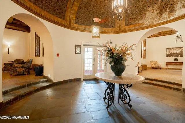 a view of a lobby with furniture and a potted plant