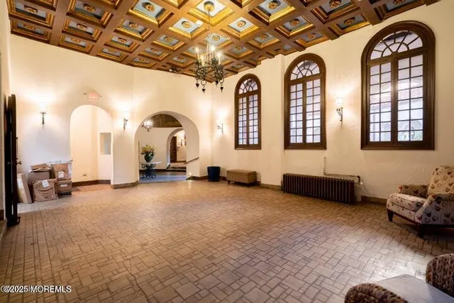 a view of a livingroom with furniture and a large window