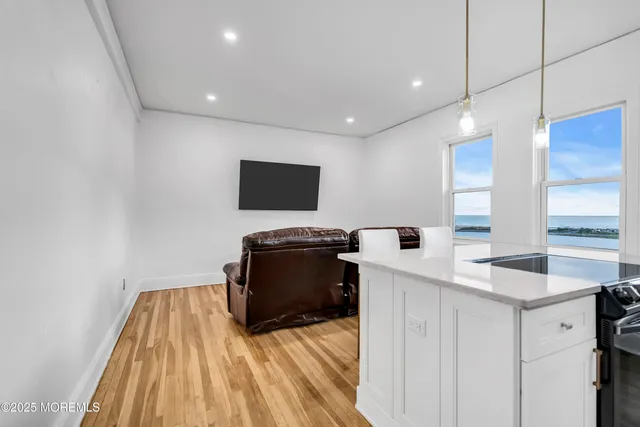 a kitchen with wooden floor and a sink