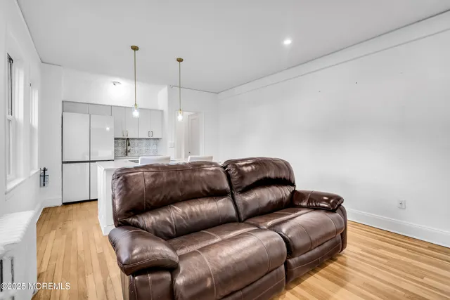 a living room with a couch and a ceiling fan