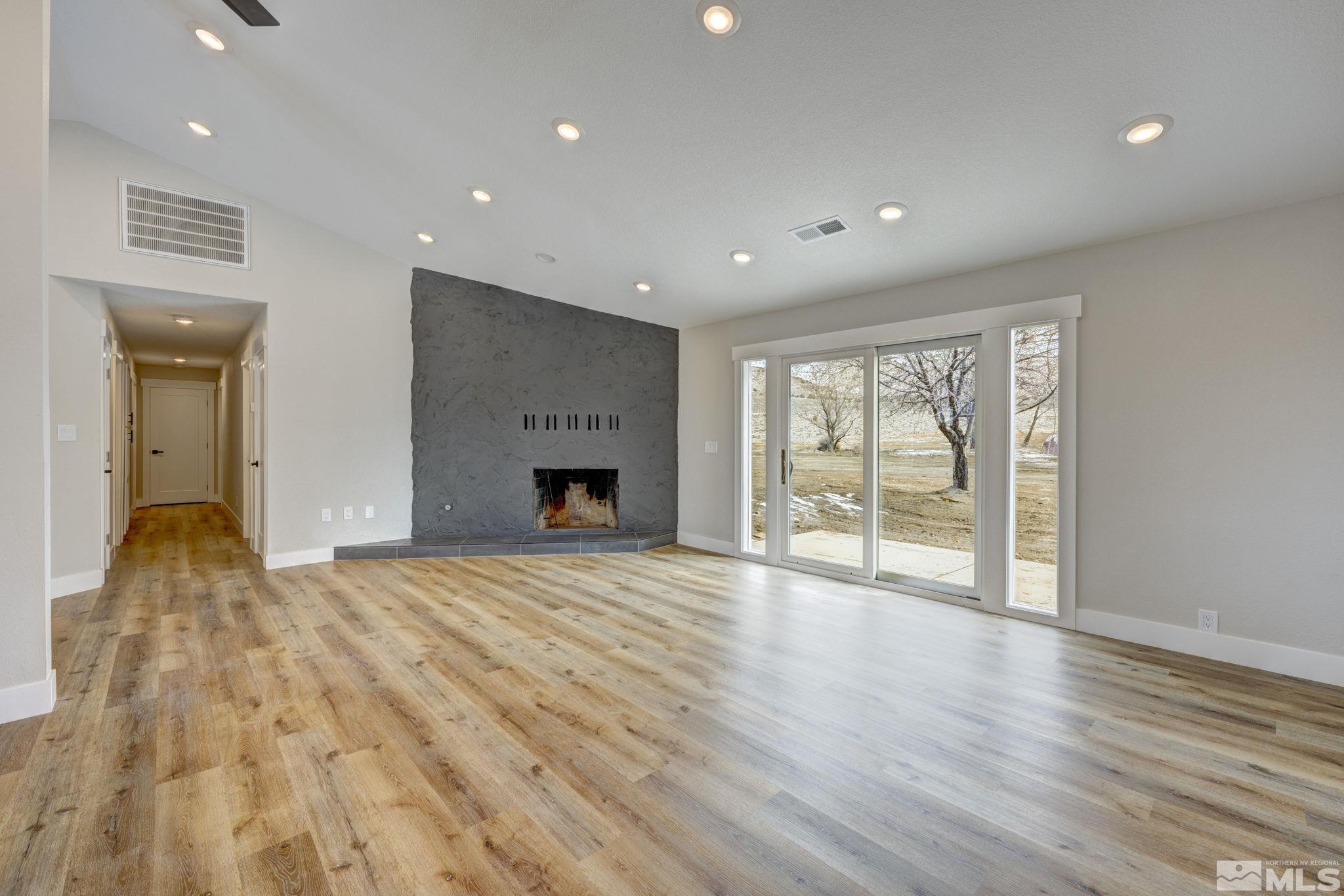 2900 Right Hand Canyon Road Reno, NV 89510 - Photo 16 of 29 a view of empty room with wooden floor and fireplace