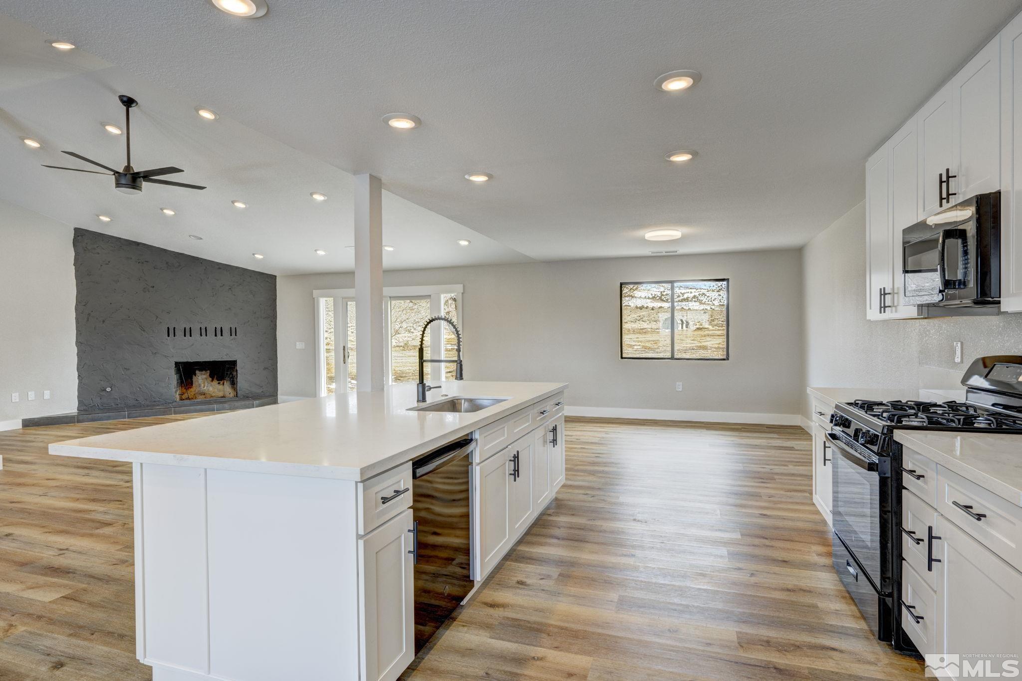 2900 Right Hand Canyon Road Reno, NV 89510 - Photo 22 of 29 a large kitchen with stainless steel appliances a large counter top a sink a stove and a refrigerator