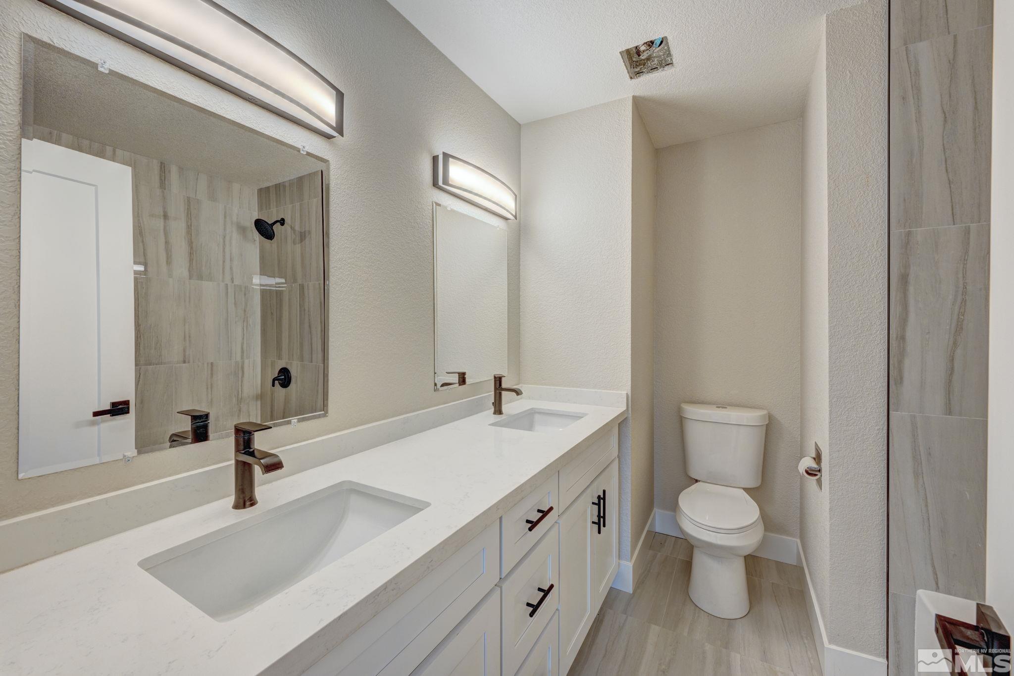 2900 Right Hand Canyon Road Reno, NV 89510 - Photo 27 of 29 a bathroom with a sink a toilet and a mirror