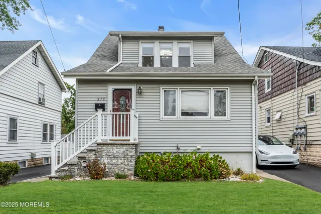 a front view of a house with a garden