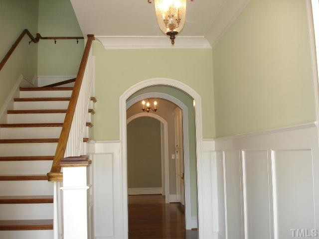 5326 Landguard Drive Raleigh, NC 27613 - Photo 5 of 17 Graceful arched wood doorways at cetral hall. True wainscotting thru-out foyer and lovely hardwood floors. Foyer