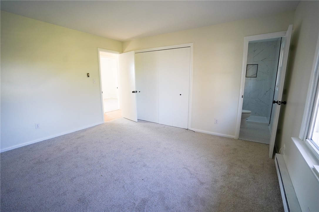 8746 Grubbs-Rex Road Arcanum, OH 45304 - Photo 8 of 38 This spacious bedroom offers comfortable living with soft carpeting and convenient access to a private bathroom.