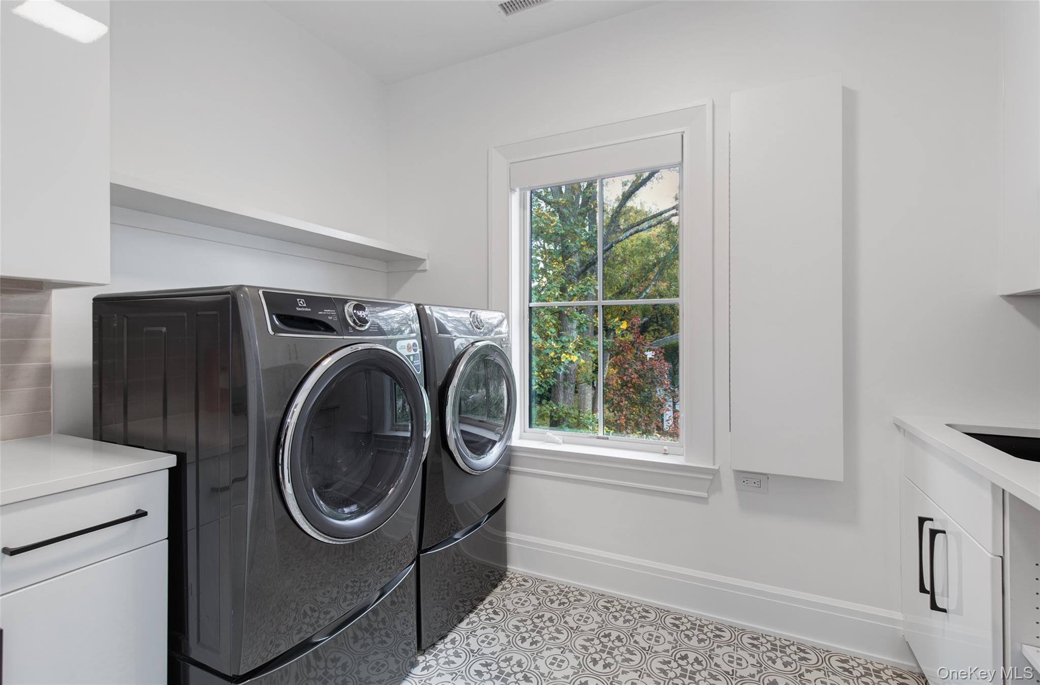 16 Myrtledale Road Scarsdale, NY 10583 - Photo 32 of 48 Second Floor Laundry room with custom cabinetry and sink