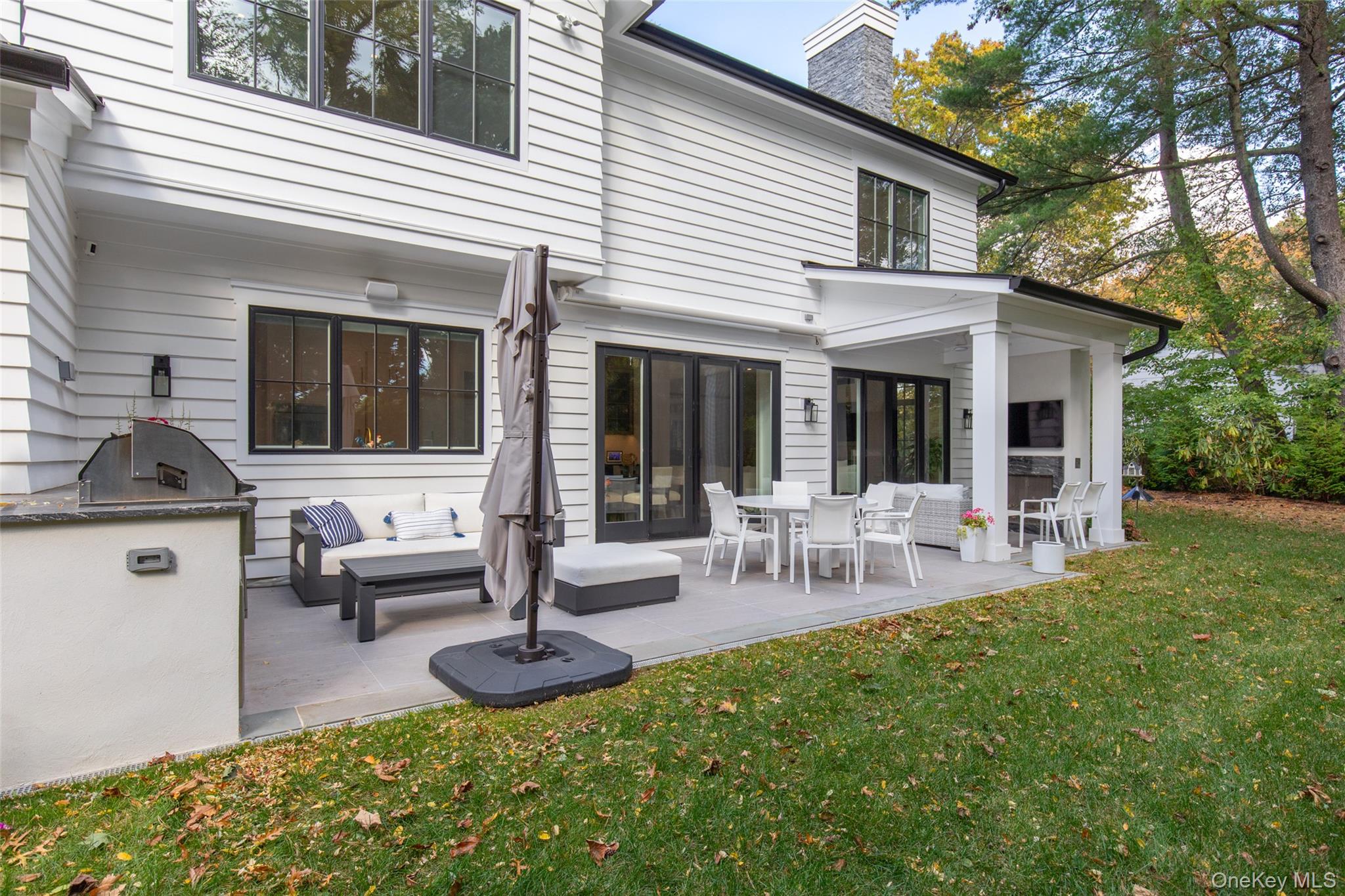 16 Myrtledale Road Scarsdale, NY 10583 - Photo 41 of 48 Rear view of property showcasing the covered porch and patio with awning and outdoor kitchen