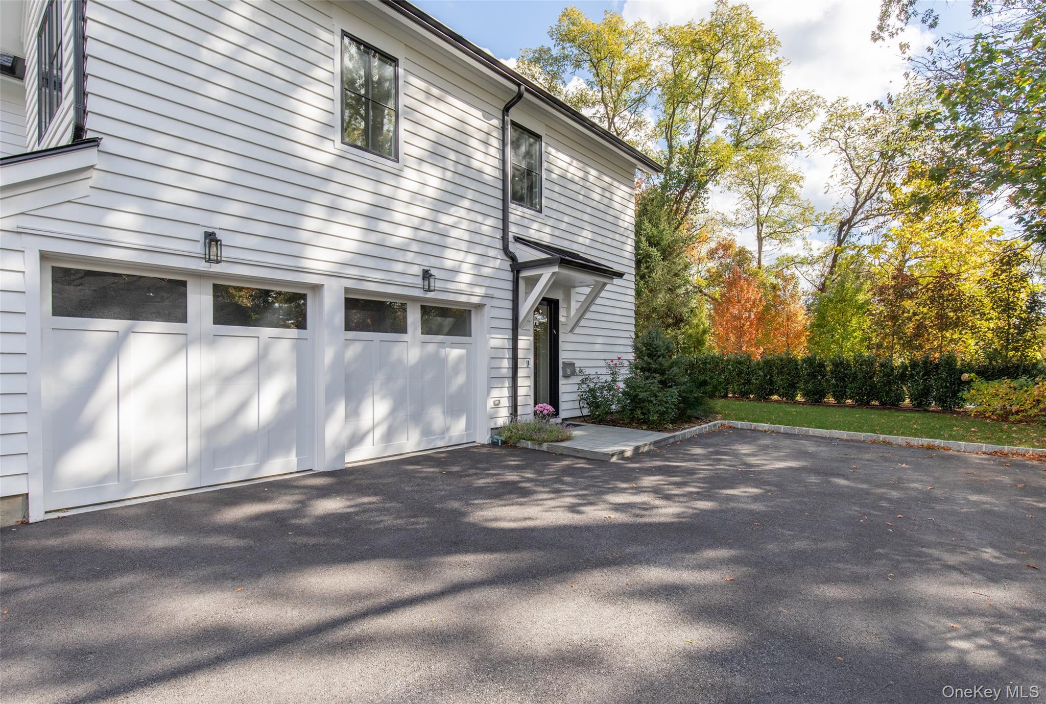 16 Myrtledale Road Scarsdale, NY 10583 - Photo 45 of 48 View of home's side exterior featuring a spacious 2 car attached garage and generous driveway