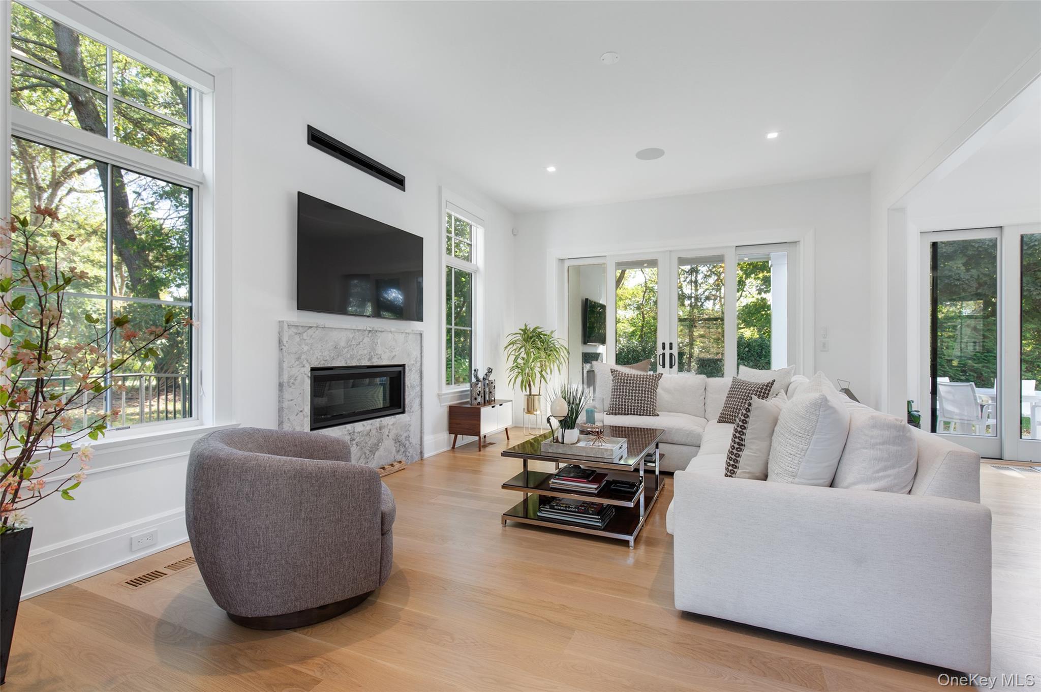 16 Myrtledale Road Scarsdale, NY 10583 - Photo 6 of 48 Family Room with gas fireplace and glass doors to covered porch opens to the kitchen