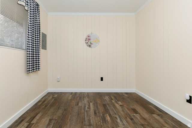 1105 Litz Road Preston, ID 83263 - Photo 12 of 24 Empty room featuring dark wood finished floors, crown molding, and electric panel