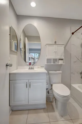 a bathroom with a sink mirror vanity and toilet