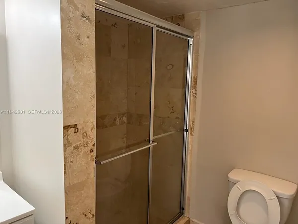 a bathroom with a shower and toilet