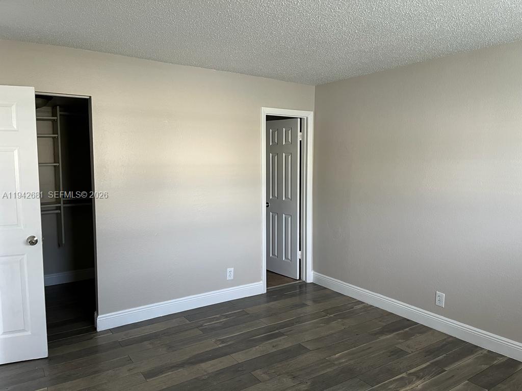 8051 South Colony Circle, Unit 109 Tamarac, FL 33321 - Photo 12 of 19 a view of an empty room with wooden floor