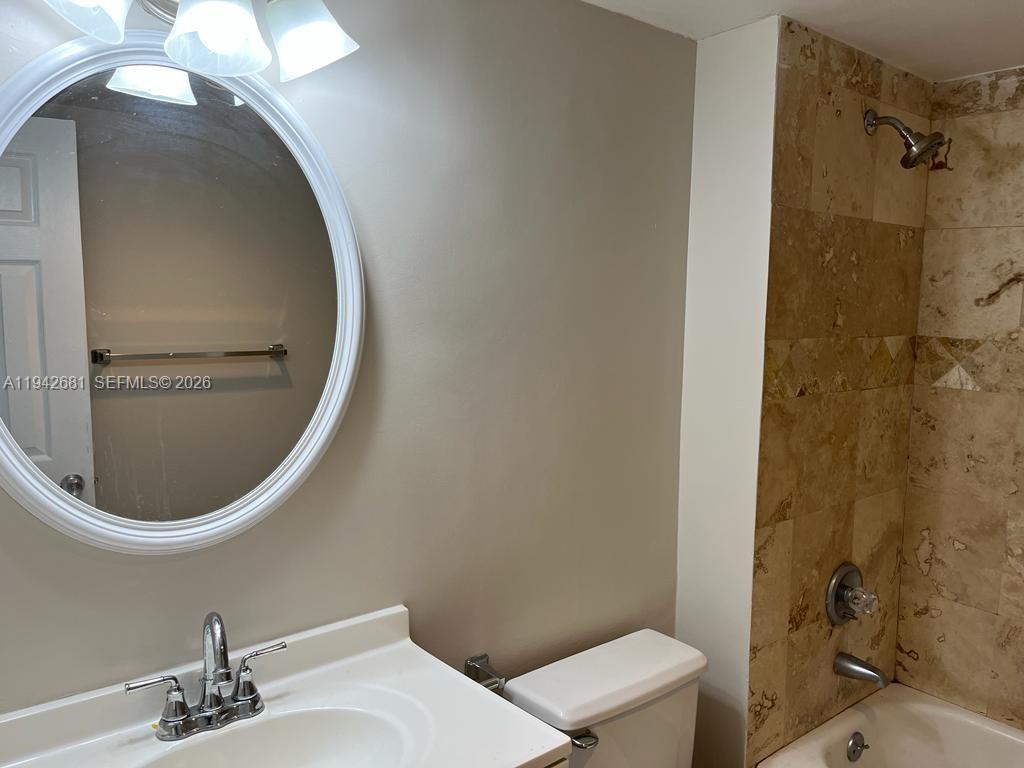 8051 South Colony Circle, Unit 109 Tamarac, FL 33321 - Photo 15 of 19 a bathroom with a sink a toilet and shower
