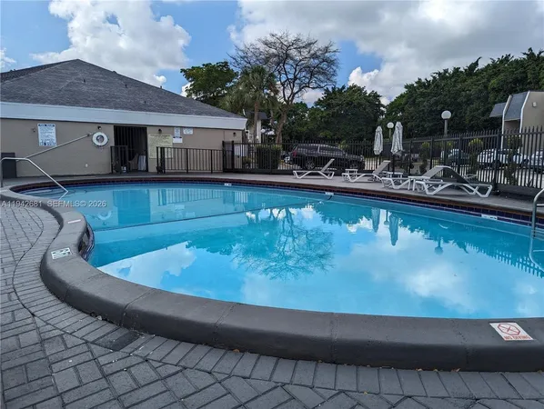 a view of a swimming pool with outdoor seating