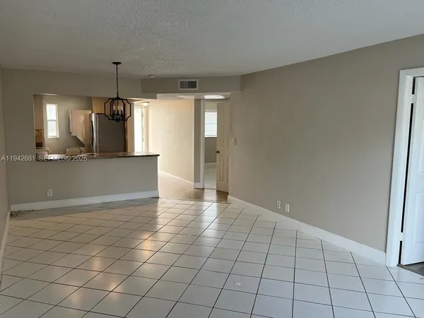 a view of a kitchen with a sink and cabinets