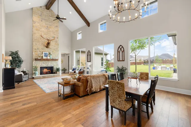 a view of a dining room with furniture a chandelier and wooden floor