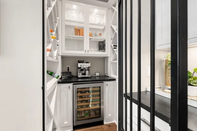 a kitchen with stainless steel appliances a refrigerator and a window