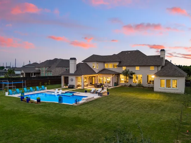 a view of a house with swimming pool and yard
