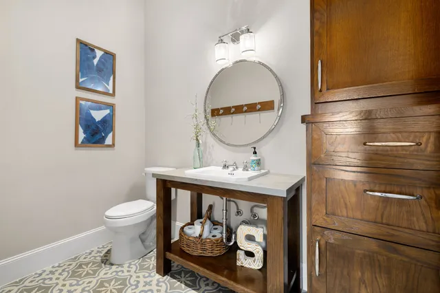 a bathroom with a toilet a sink and mirror