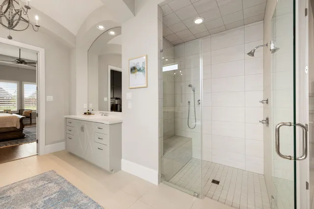 a bathroom with a shower sink and mirror