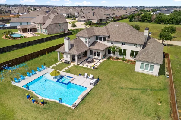 an aerial view of a house with a swimming pool