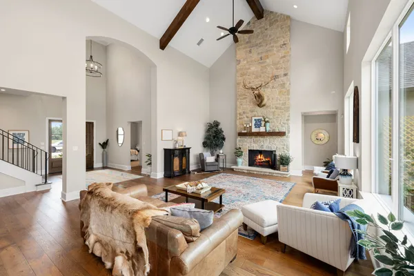 a living room with furniture large window and a fireplace