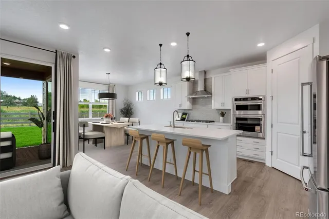 a kitchen with counter top space a sink appliances and cabinets