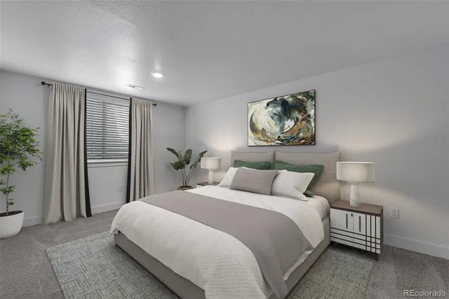 a bedroom with a bed and a potted plant