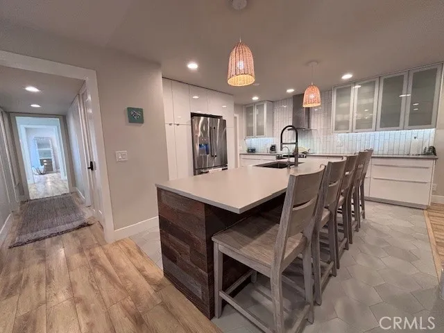 a dining area with a table chairs and a kitchen view
