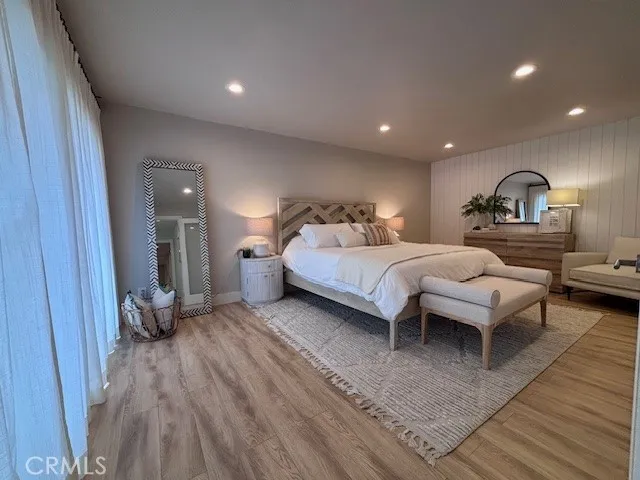 a spacious bedroom with a bed a couch and a dresser