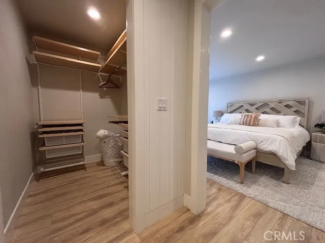 a bedroom with a bed and a view of closet