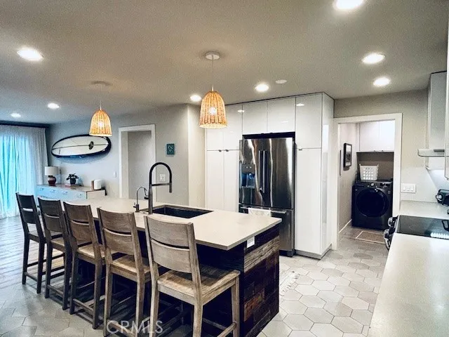 a large kitchen with a table and chairs