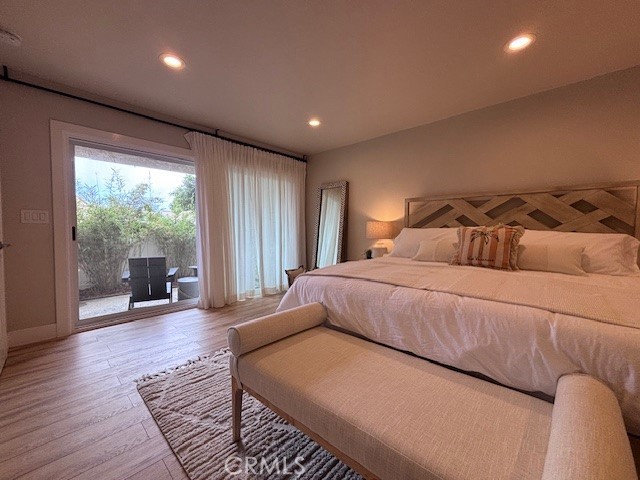 2920 Camino Capistrano, Unit 9D San Clemente, CA 92672 - Photo 22 of 54 a bedroom with a bed and glass door