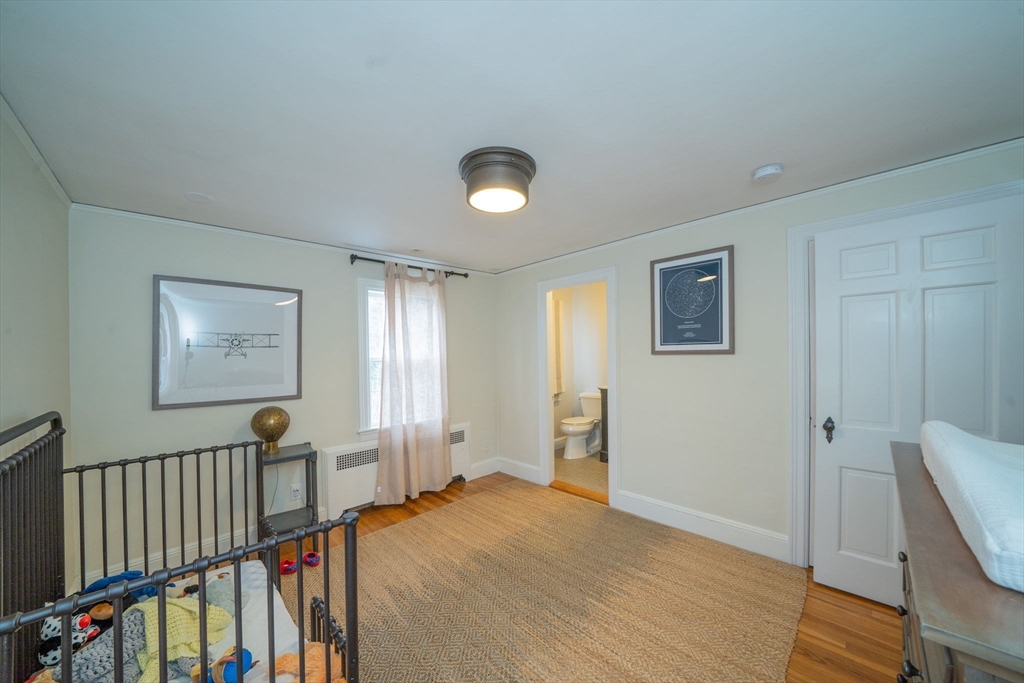 642 Centre Street Newton, MA 02458 - Photo 18 of 37 a view of a hallway to a livingroom with furniture and staircase