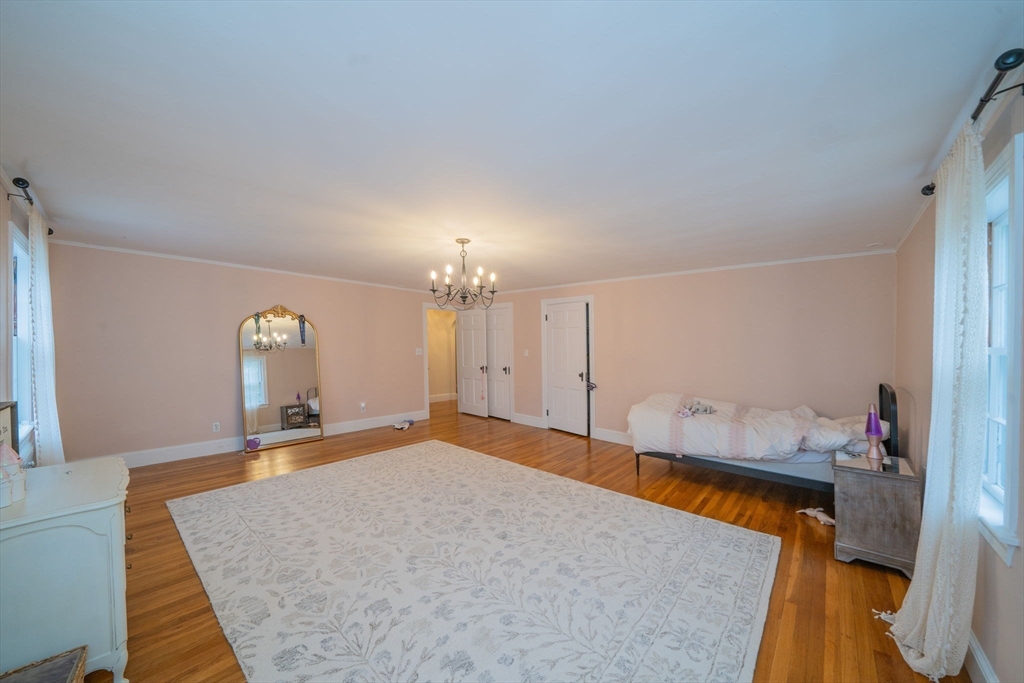 642 Centre Street Newton, MA 02458 - Photo 26 of 37 a bedroom with a bed and a dresser in it