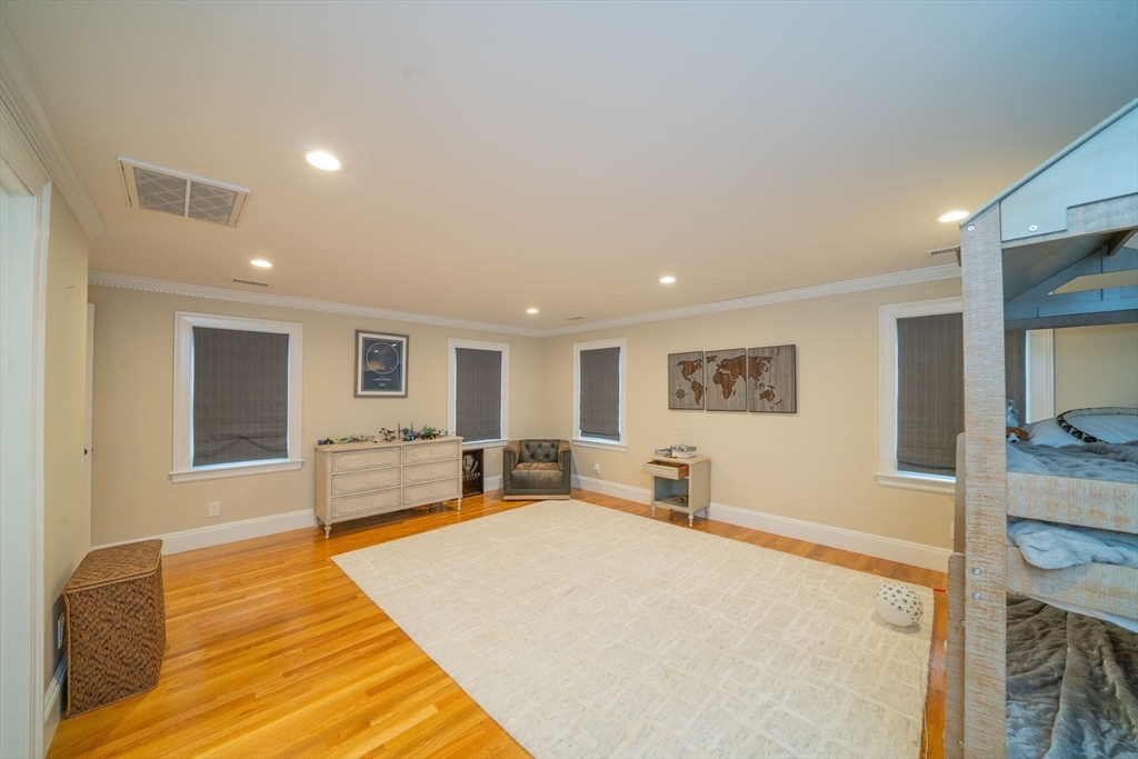 642 Centre Street Newton, MA 02458 - Photo 28 of 37 a spacious bedroom with a large bed and a couch