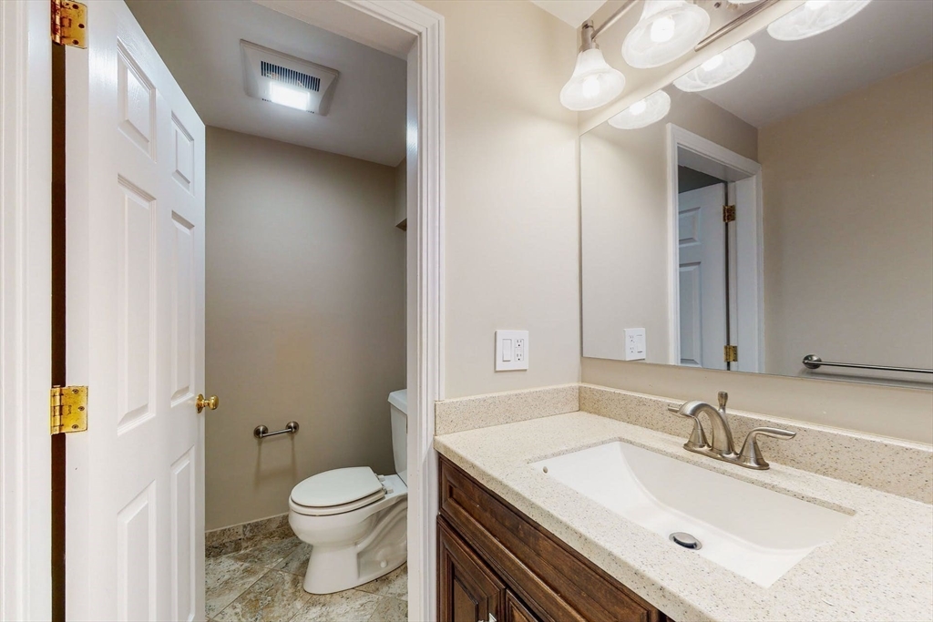 642 Centre Street Newton, MA 02458 - Photo 33 of 37 a bathroom with a sink vanity mirror and toilet