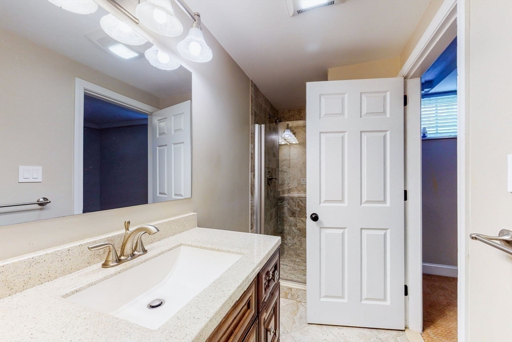 642 Centre Street Newton, MA 02458 - Photo 34 of 37 a bathroom with a sink vanity and a mirror