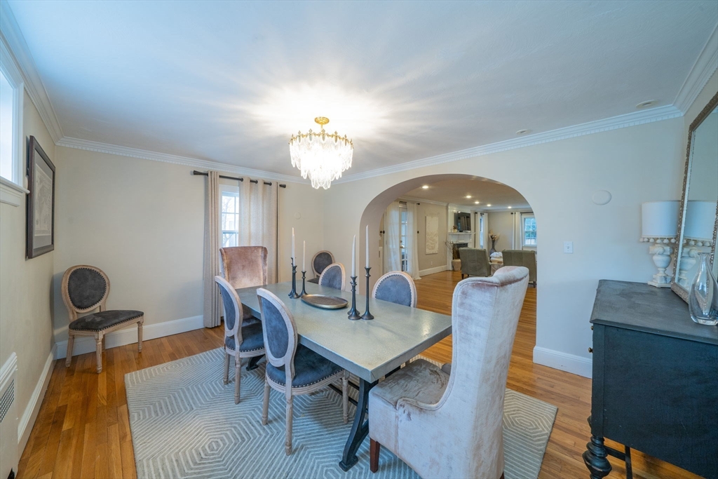 642 Centre Street Newton, MA 02458 - Photo 9 of 37 a view of a dining room with furniture and a chandelier