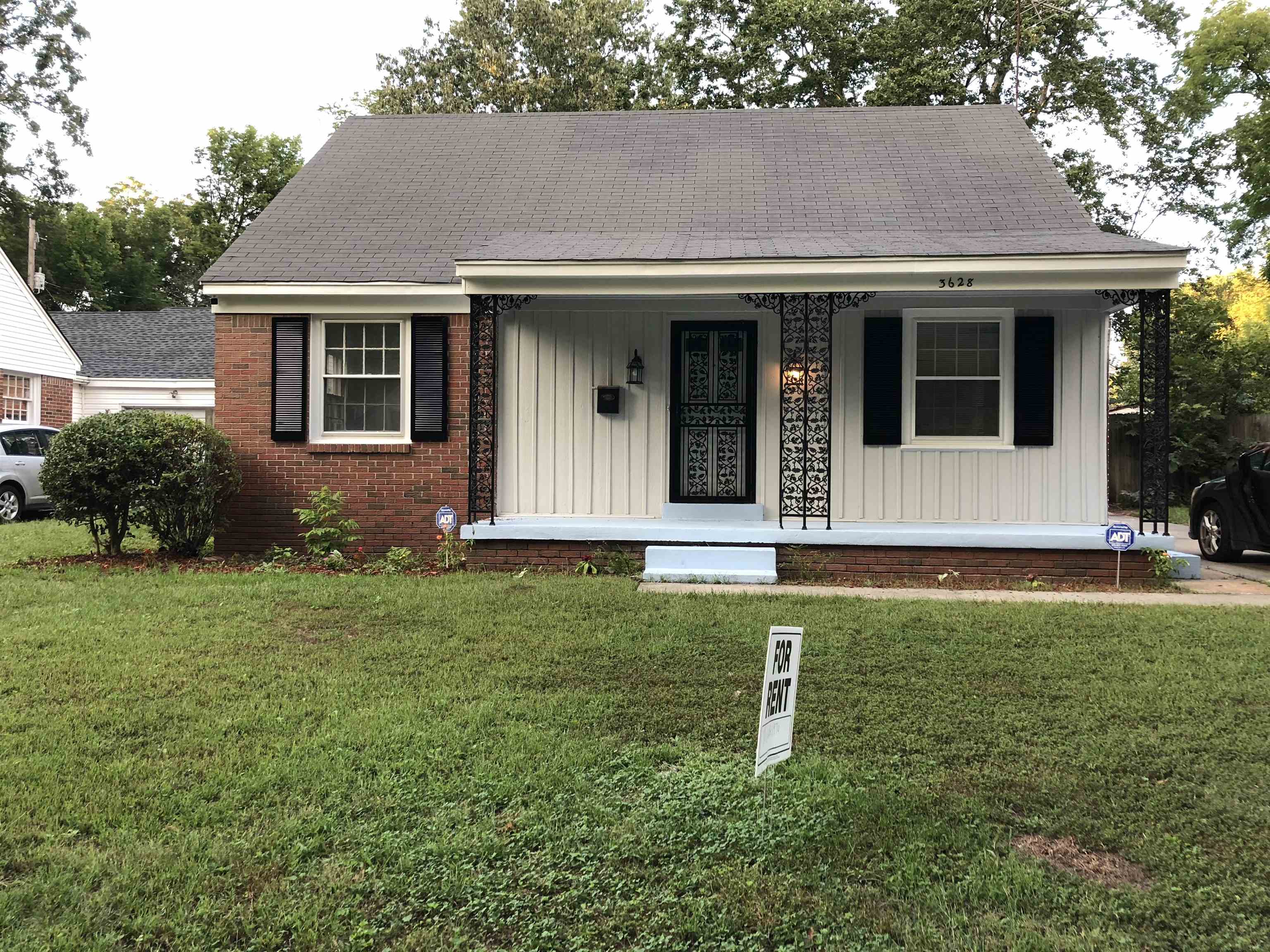 View of front of house featuring a front lawn and covered porch