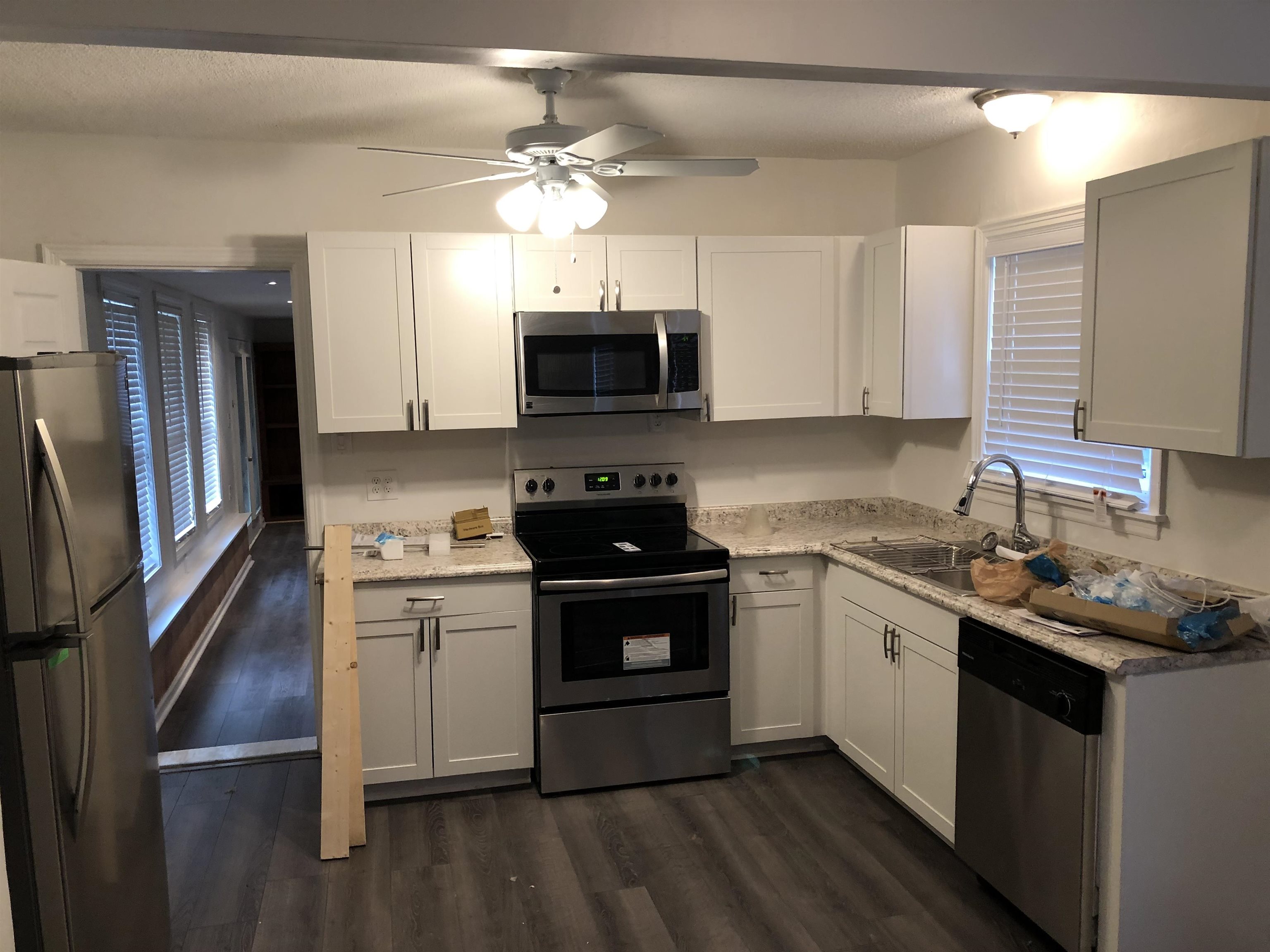 3628 Carrington Road Memphis, TN 38111 - Photo 2 of 11 Kitchen featuring dark wood-type flooring, white cabinetry, appliances with stainless steel finishes, and sink