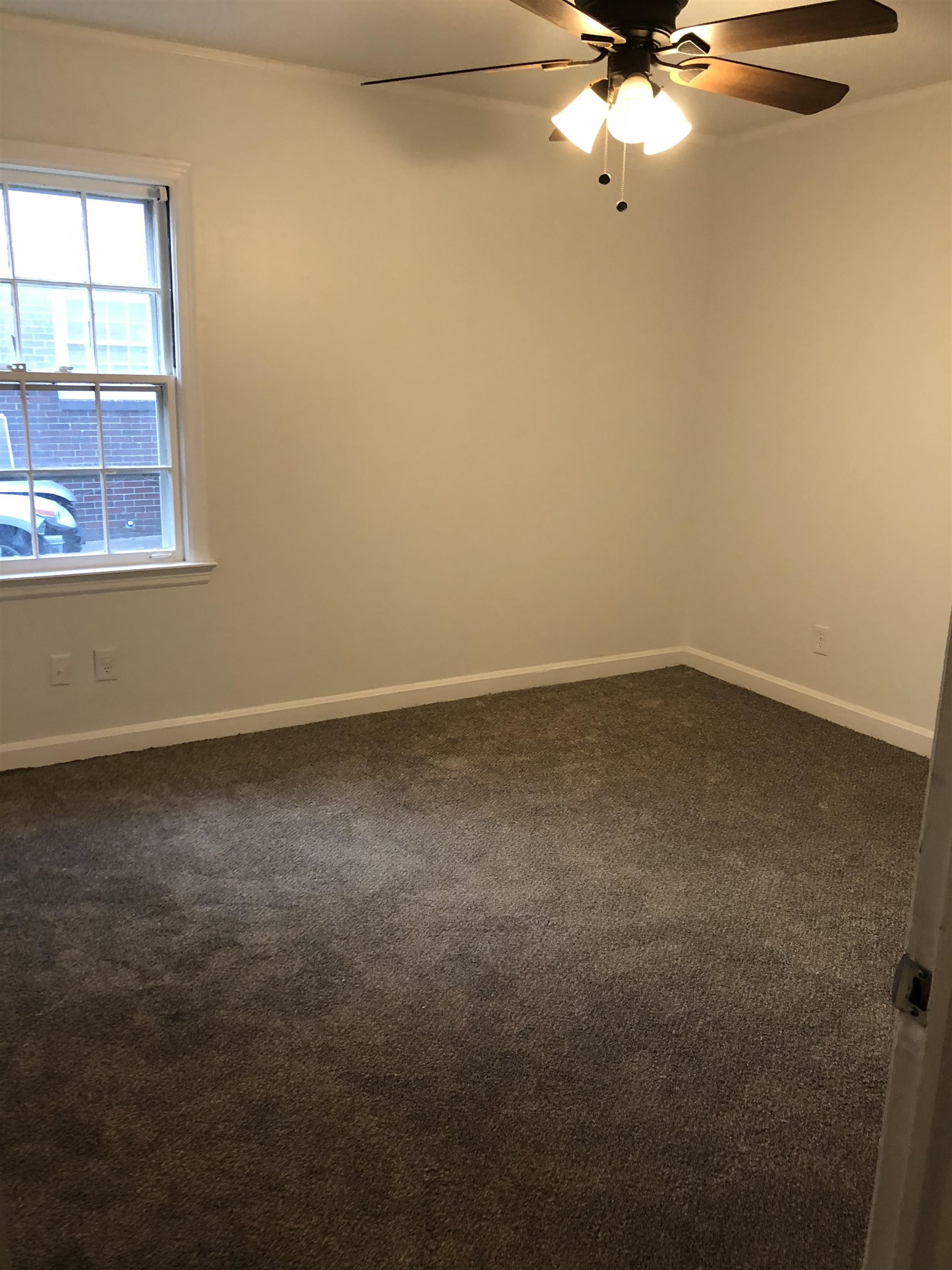 3628 Carrington Road Memphis, TN 38111 - Photo 6 of 11 Spare room with dark colored carpet and ceiling fan