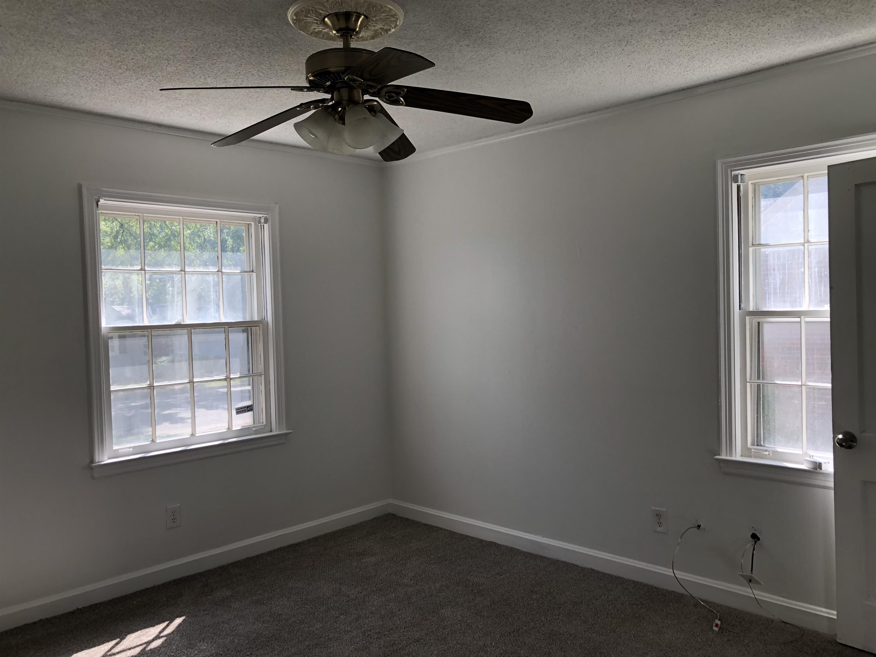 3628 Carrington Road Memphis, TN 38111 - Photo 8 of 11 Spare room featuring a textured ceiling, dark colored carpet, a wealth of natural light, and ceiling fan