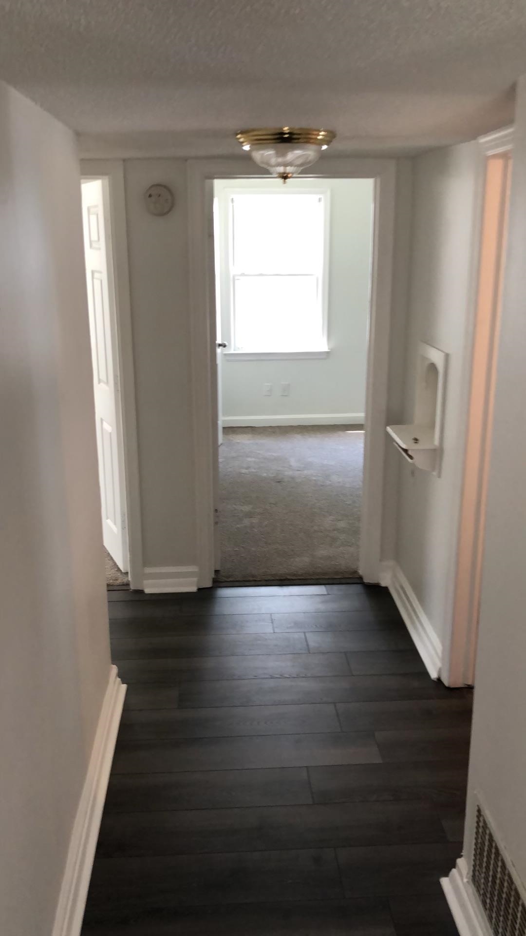 3628 Carrington Road Memphis, TN 38111 - Photo 9 of 11 Hallway featuring dark wood-type flooring and a textured ceiling