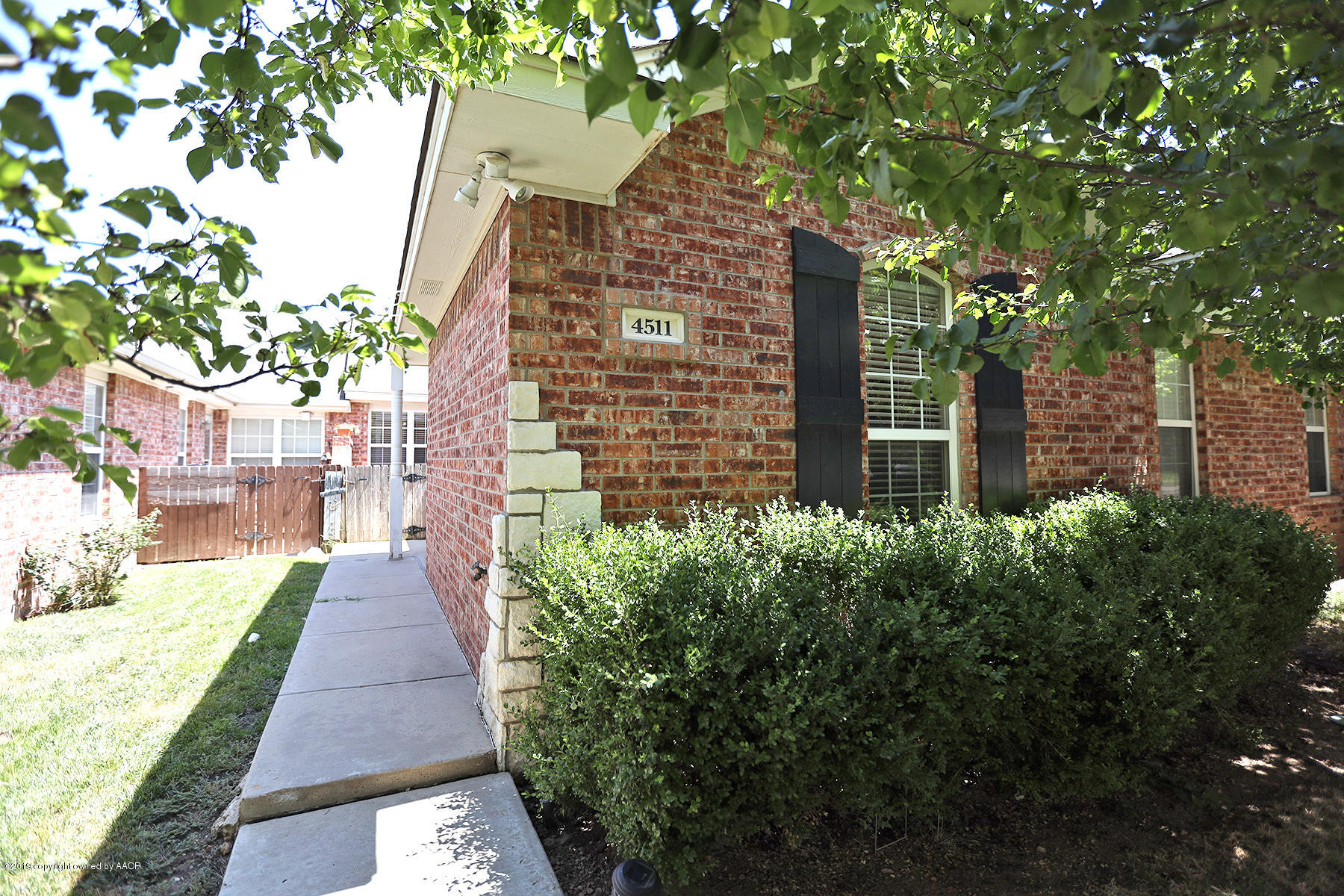 4511 Steffi Court Amarillo, TX 79110 - Photo 1 of 1 a pathway of a house with a yard